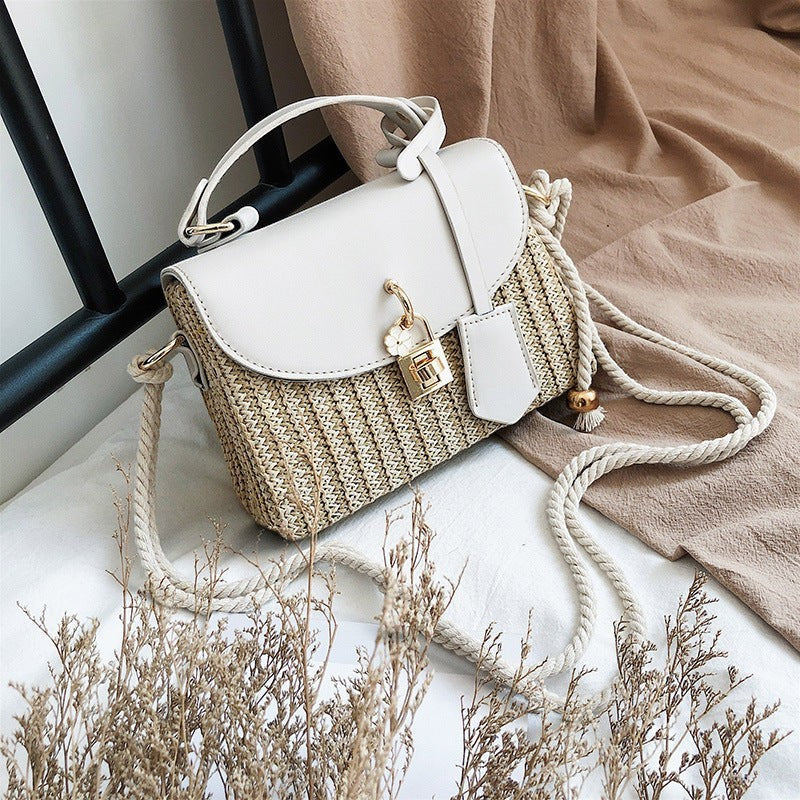 Lunéra de Paris alabaster woven crossbody bag with a smooth flap, top handle, and nautical rope shoulder strap.
