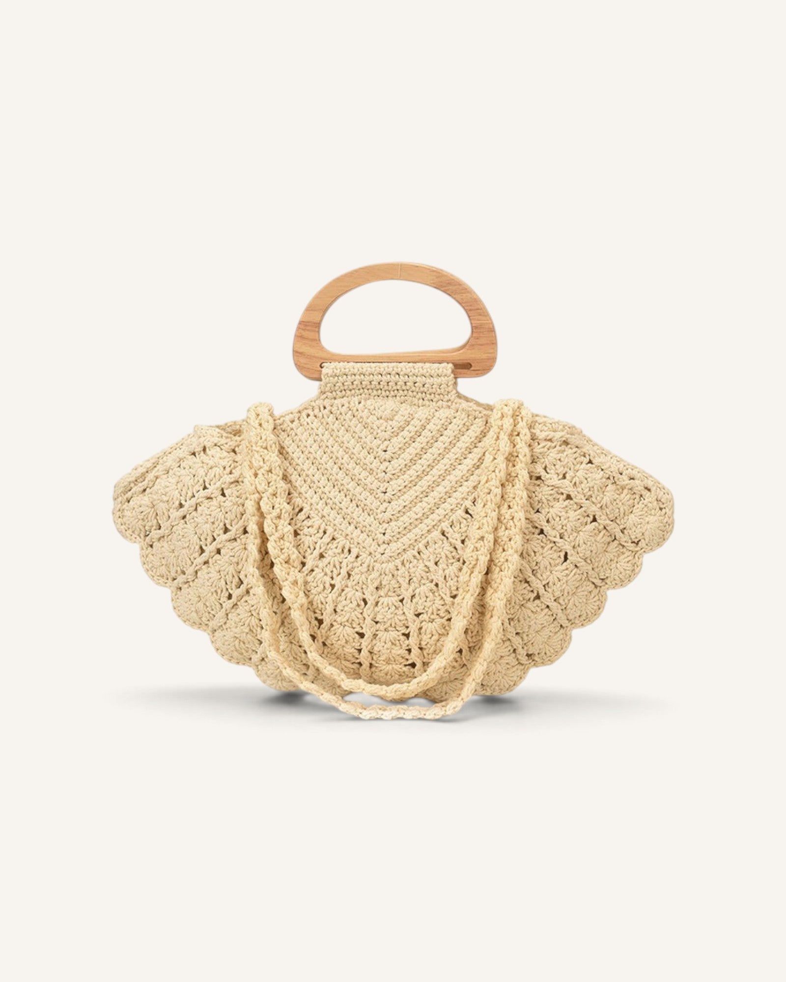 Lunéra de Paris beige woven shell-shaped handbag with a wooden top handle and shoulder strap for resort styling.
