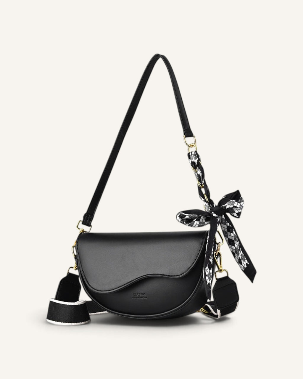 Lunéra de Paris black curved flap crossbody bag with a patterned scarf detail and wide adjustable shoulder strap.
