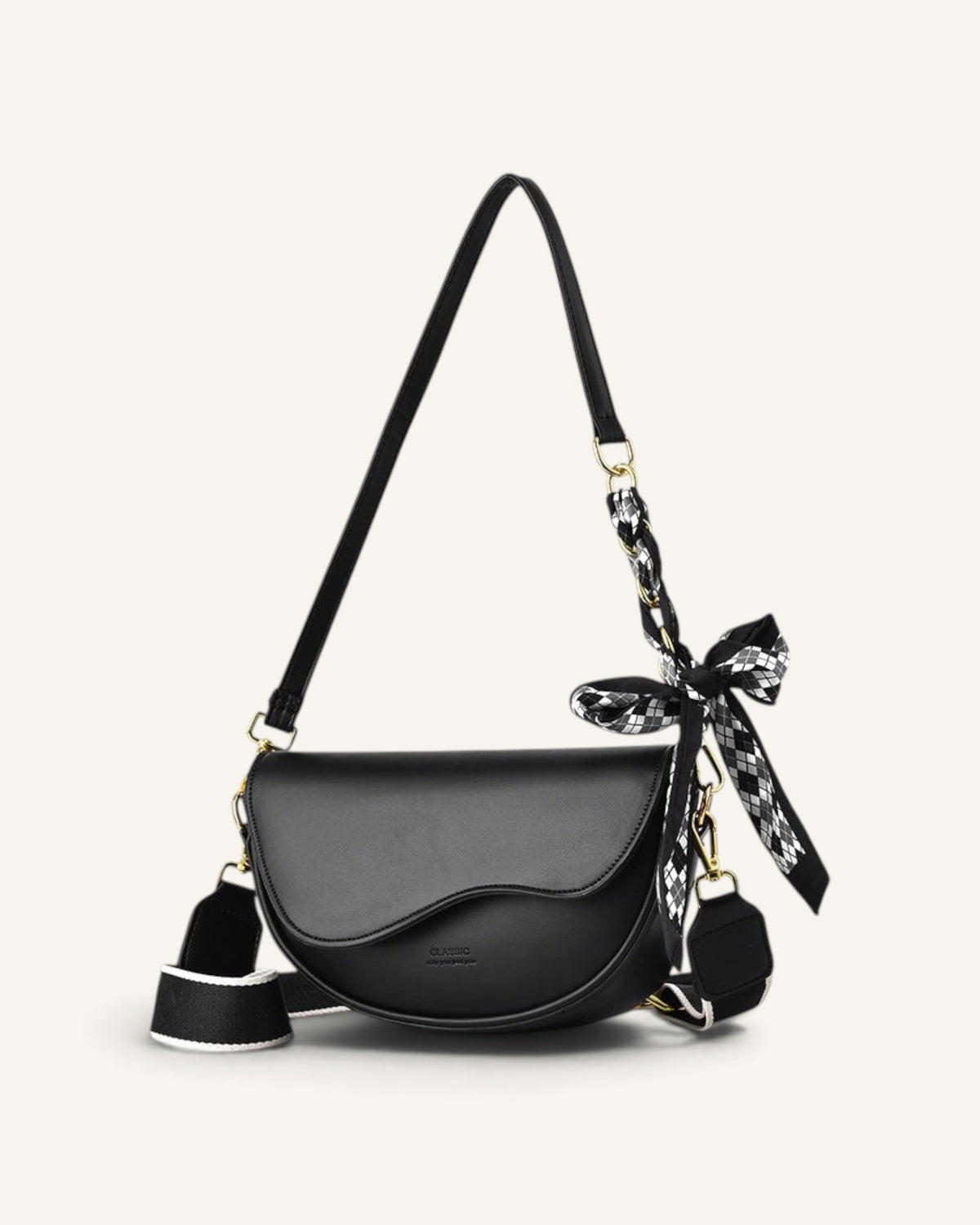 Lunéra de Paris black curved flap crossbody bag with a patterned scarf detail and wide adjustable shoulder strap.