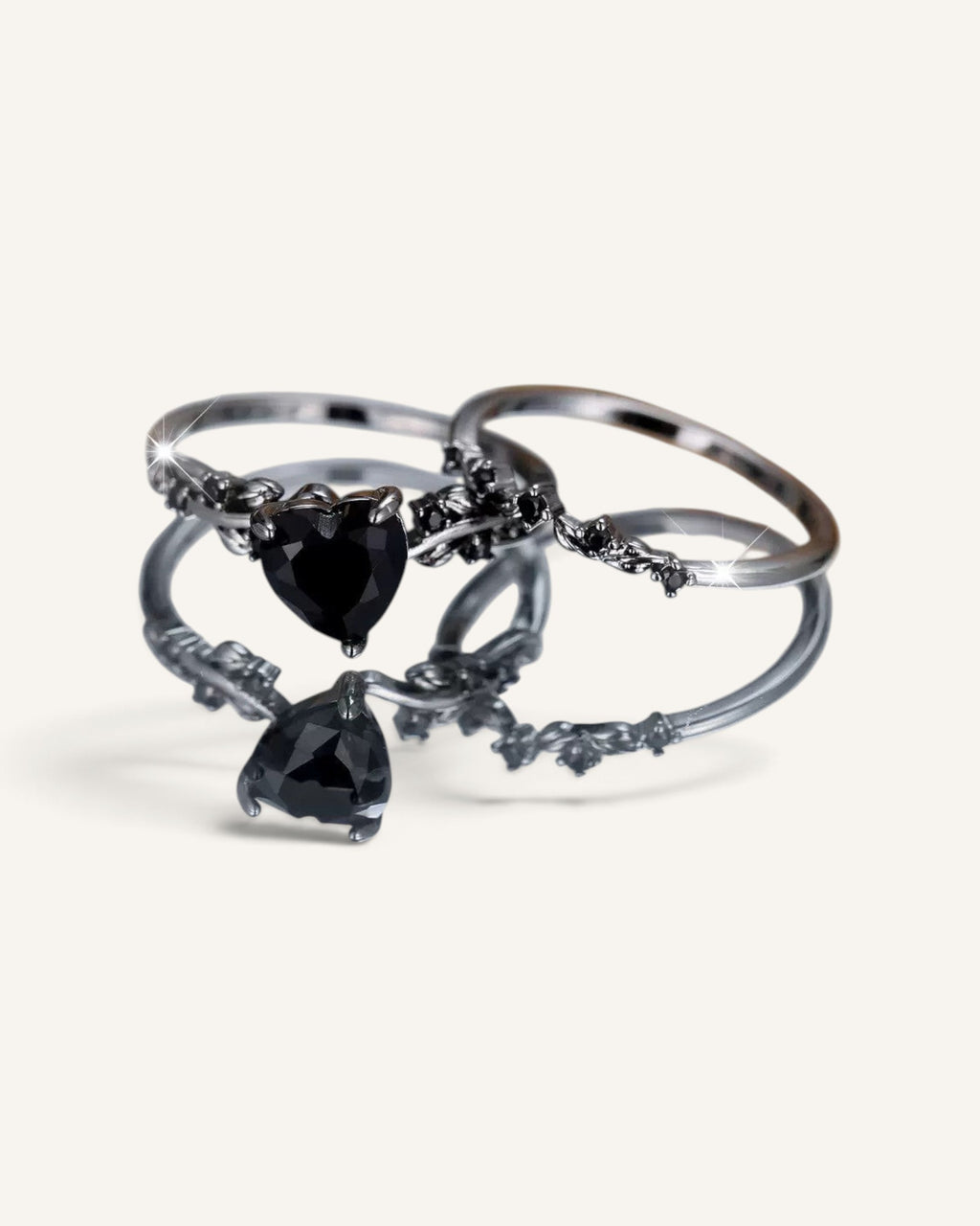 Lunéra de Paris two-piece stackable ring set featuring black heart-shaped zircon stones and botanical leaf-inspired bands.