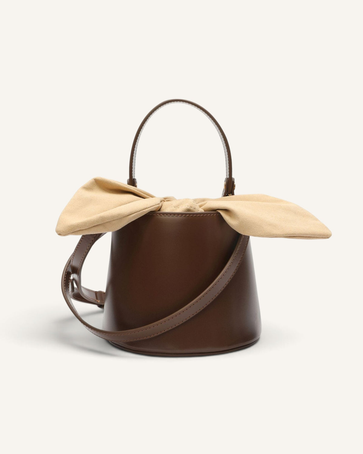 Lunéra de Paris brown structured bucket bag with a beige fabric bow accent and adjustable shoulder strap