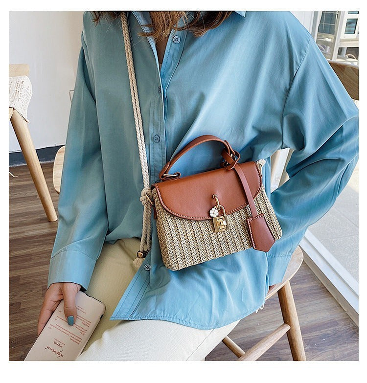 Lunéra de Paris cognac woven crossbody bag with top handle, rope strap, and floral charm worn by a woman