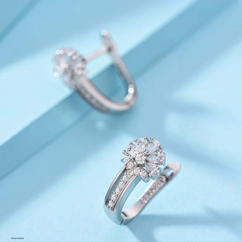 Lunéra de Paris silver-tone hoop earrings featuring a floral cluster motif with clear stone accents