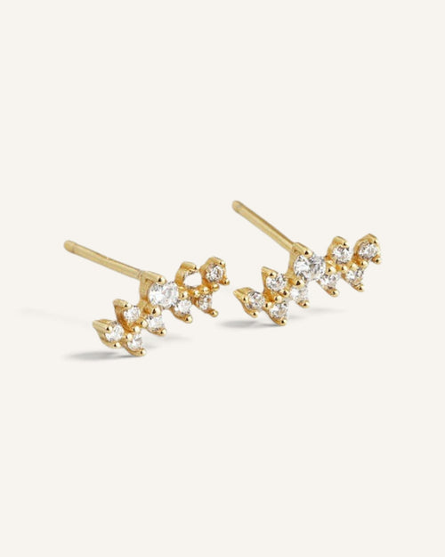 Lunéra de Paris gold-tone cluster stud earrings with sparkling clear stones in a delicate celestial-inspired design.