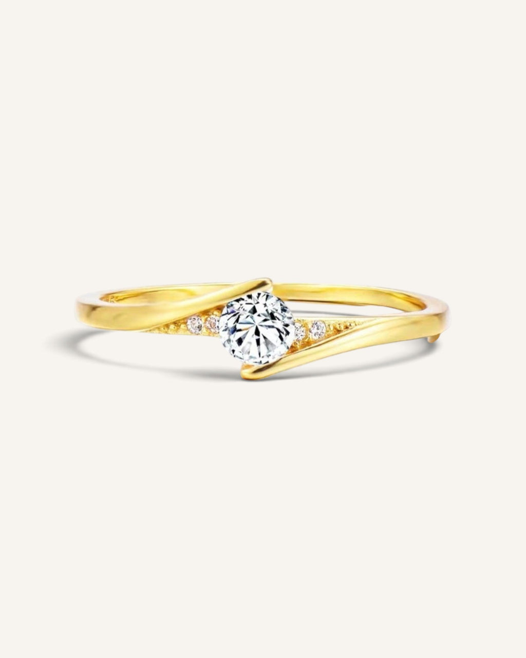 Lunéra de Paris gold crossover solitaire ring with a central round stone and delicate accent crystals