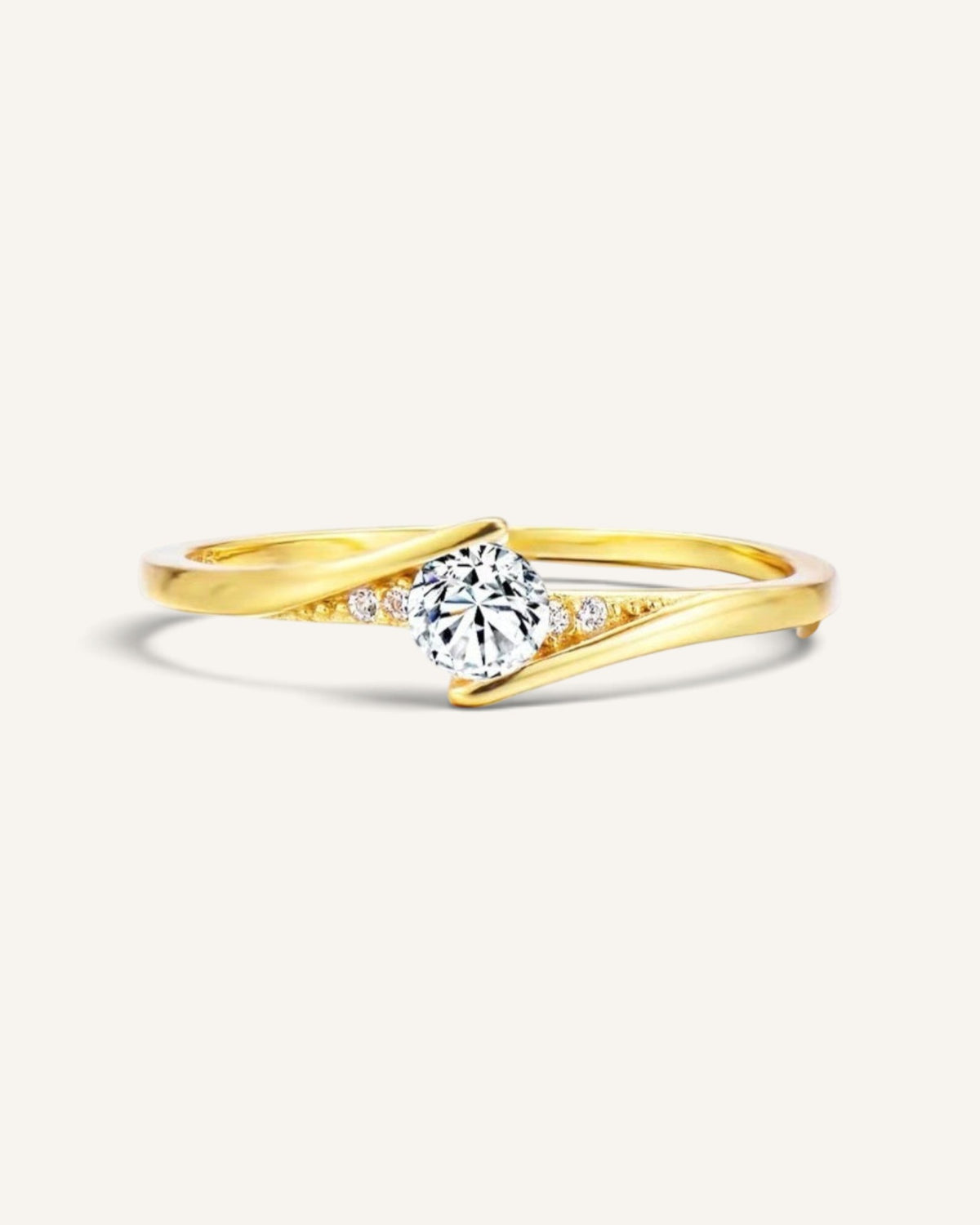 Lunéra de Paris gold crossover solitaire ring with a central round stone and delicate accent crystals