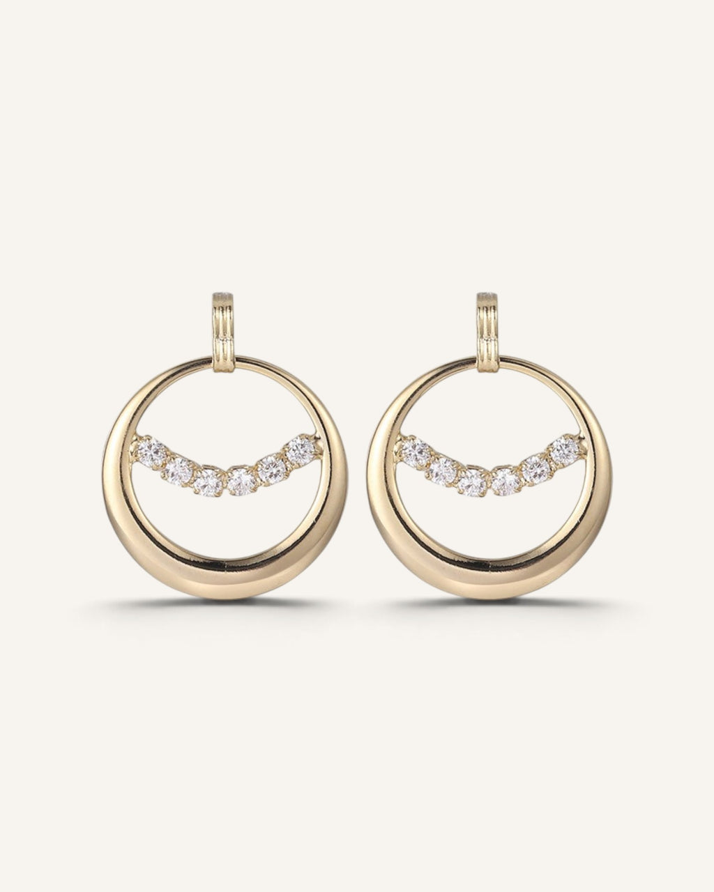 Lunéra de Paris gold circular hoop earrings featuring a curved row of sparkling clear crystal accents.