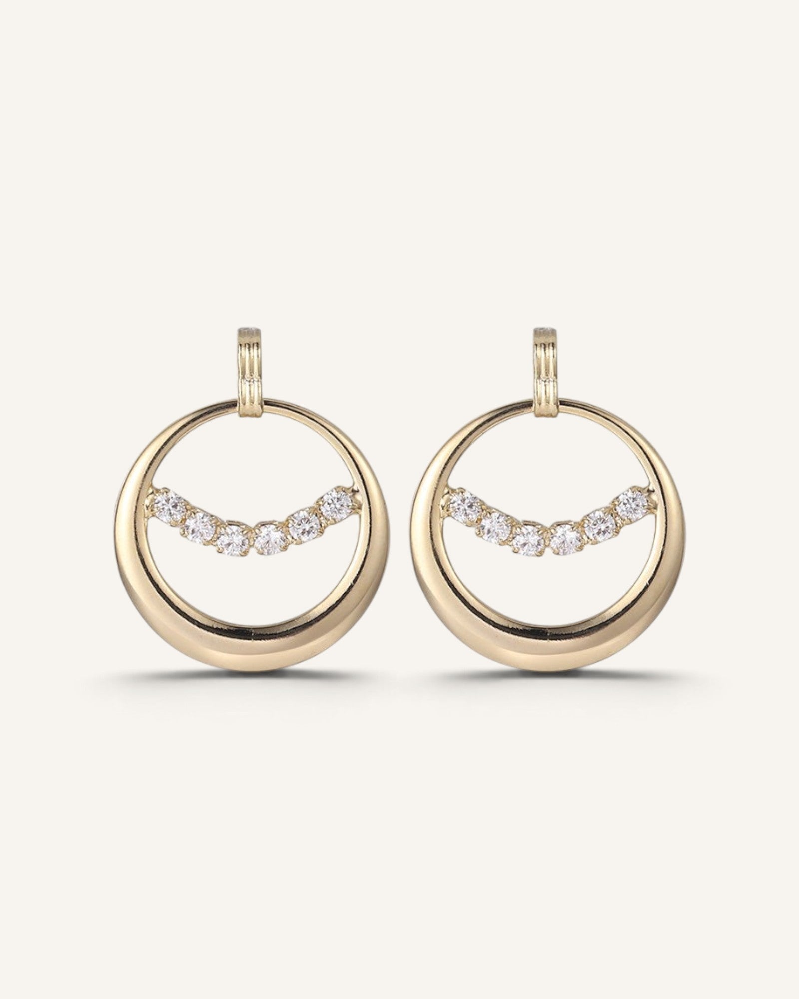 Lunéra de Paris gold circular hoop earrings featuring a curved row of sparkling clear crystal accents.