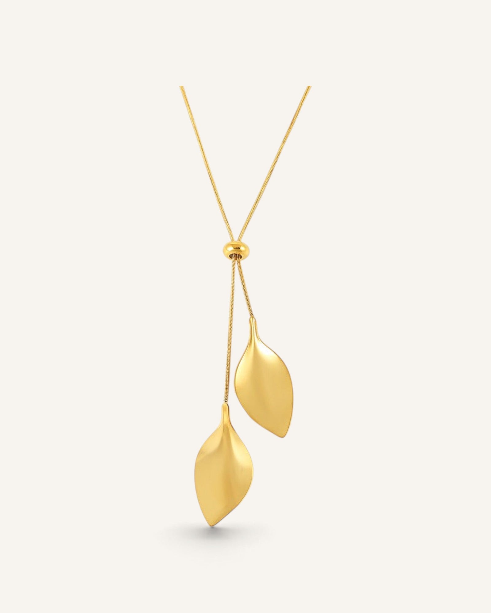 Lunéra de Paris gold dual leaf pendant necklace with a minimalist botanical design on a smooth adjustable chain