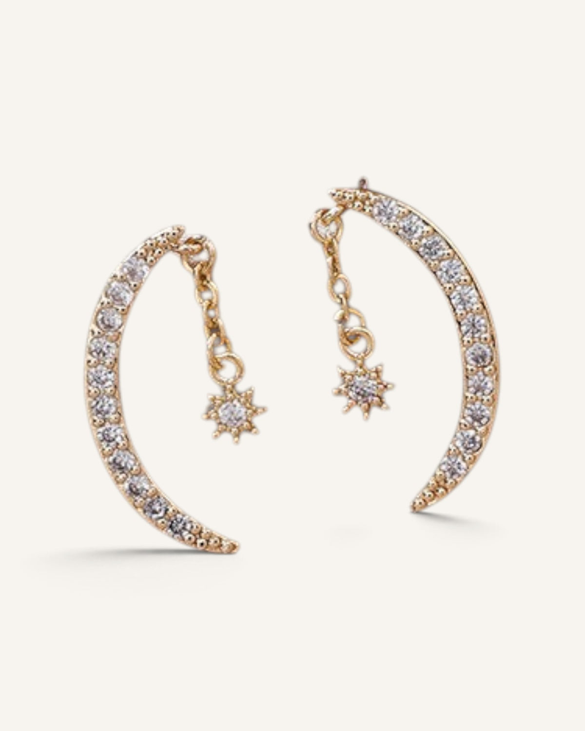 Lunéra de Paris gold crescent moon drop earrings with dangling star charms and sparkling stone accents