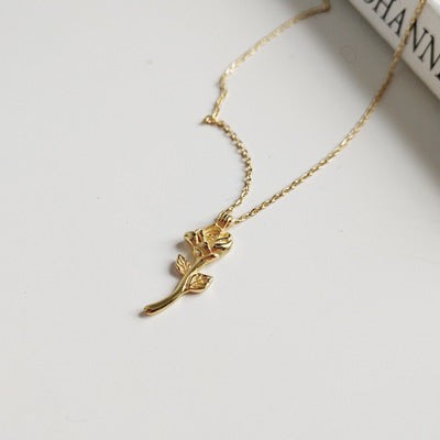 Lunéra de Paris gold-tone necklace featuring a delicate sculpted rose pendant with stem and leaf detailing