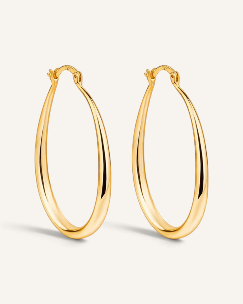 Lunéra de Paris gold teardrop hoop earrings with a polished finish and secure hinged closure