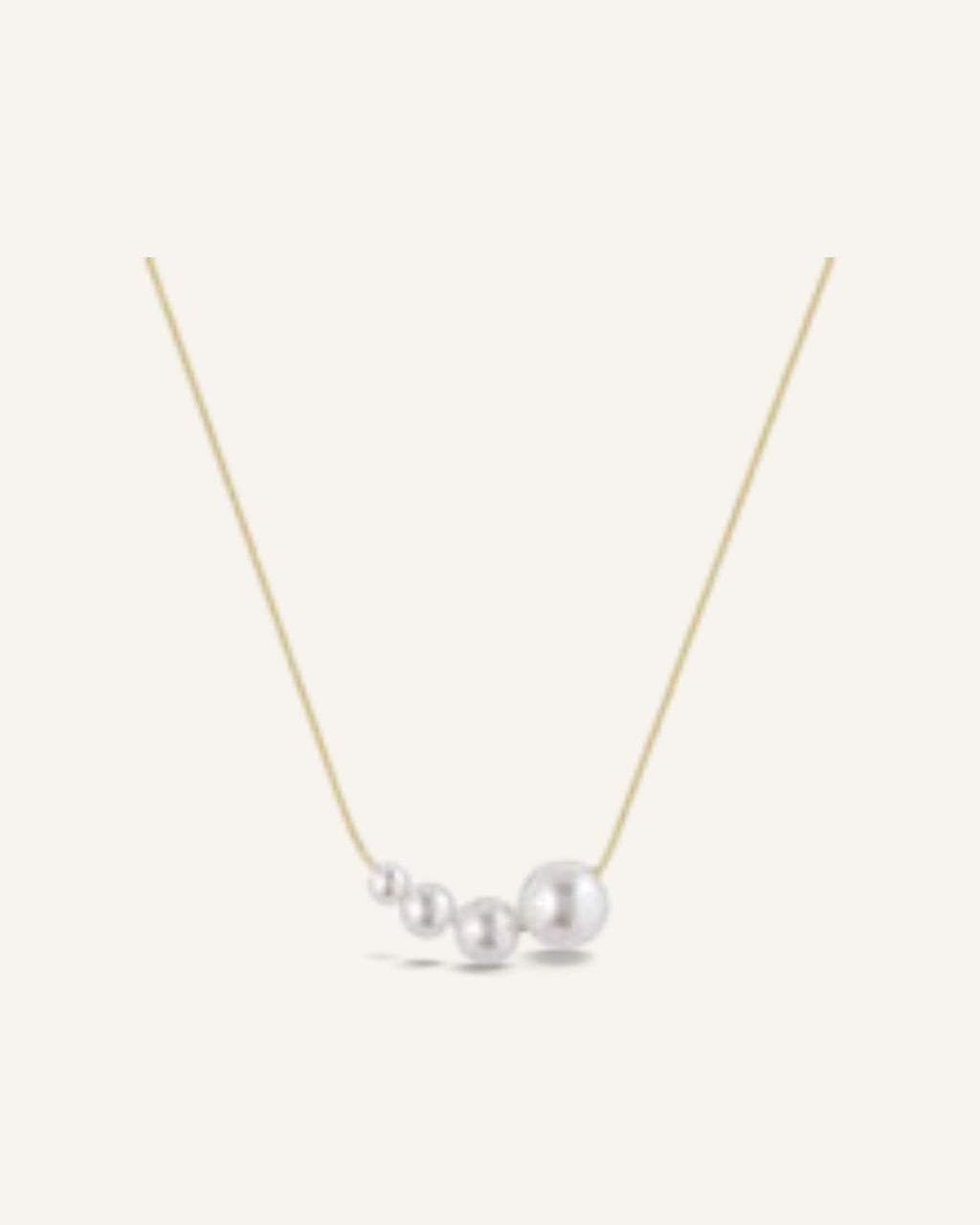 Lunéra de Paris gold-tone necklace featuring a delicate chain and a cluster of four graduated white pearls