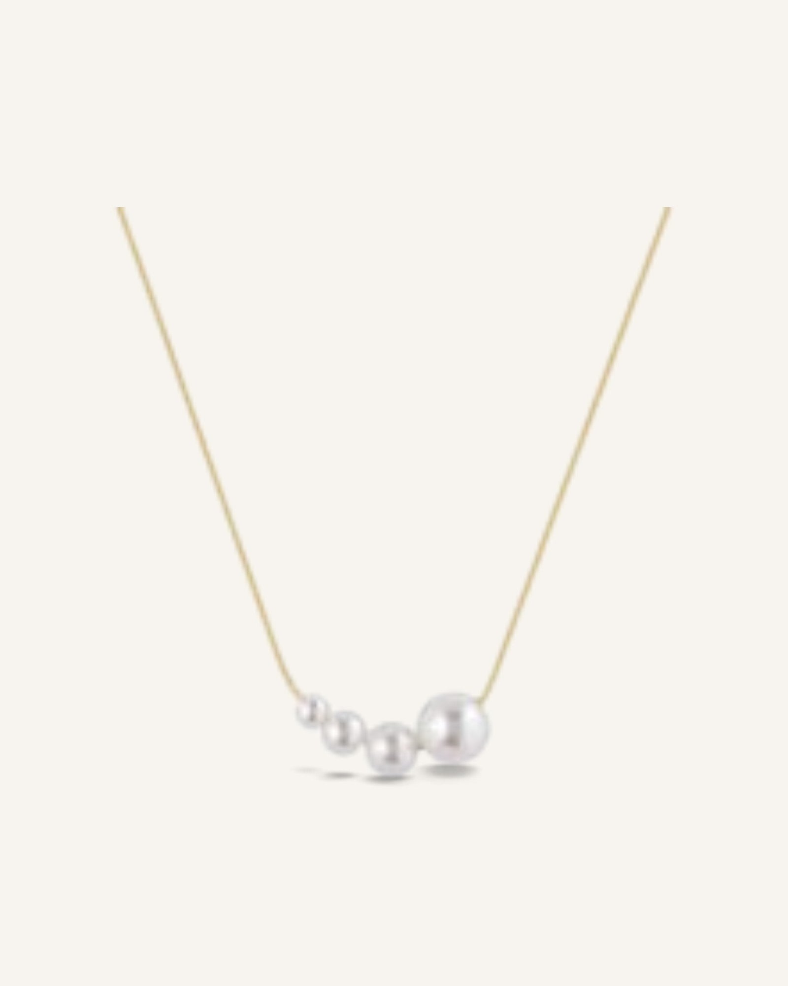 Lunéra de Paris gold-tone necklace featuring a delicate chain and a cluster of four graduated white pearls