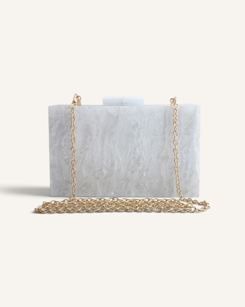 Lunéra de Paris white marble-effect acrylic box clutch with a gold chain strap for formal evening wear.