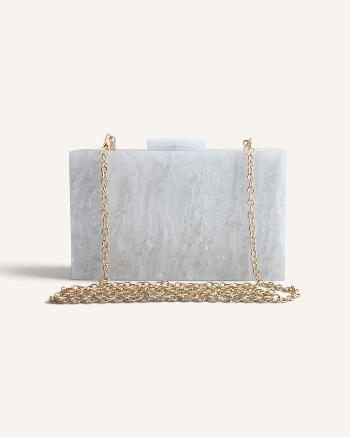 Lunéra de Paris white marble-effect acrylic box clutch with a gold chain strap for formal evening wear.