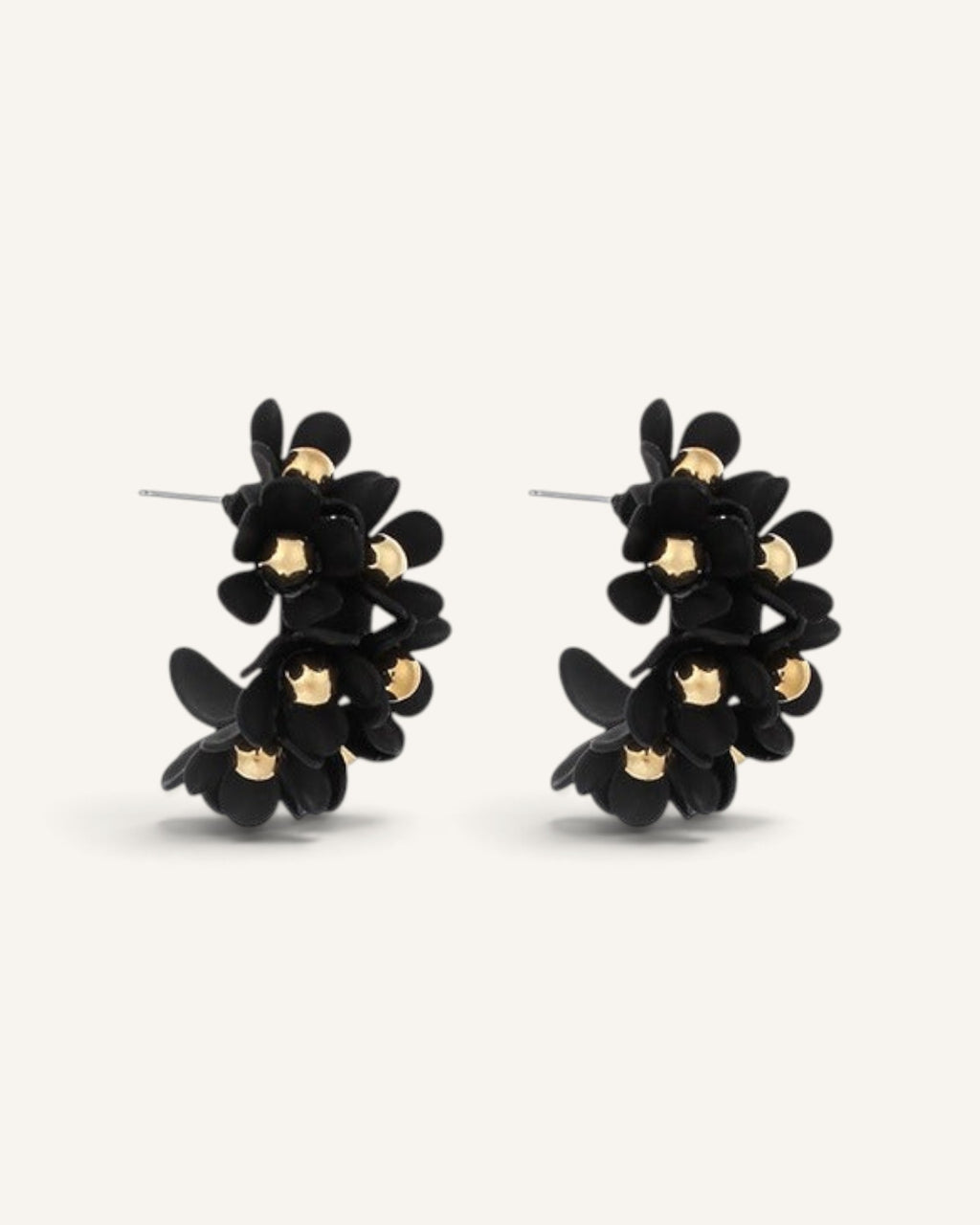 Lunéra de Paris matte black U-shaped hoop earrings featuring dimensional floral motifs with polished gold centers.