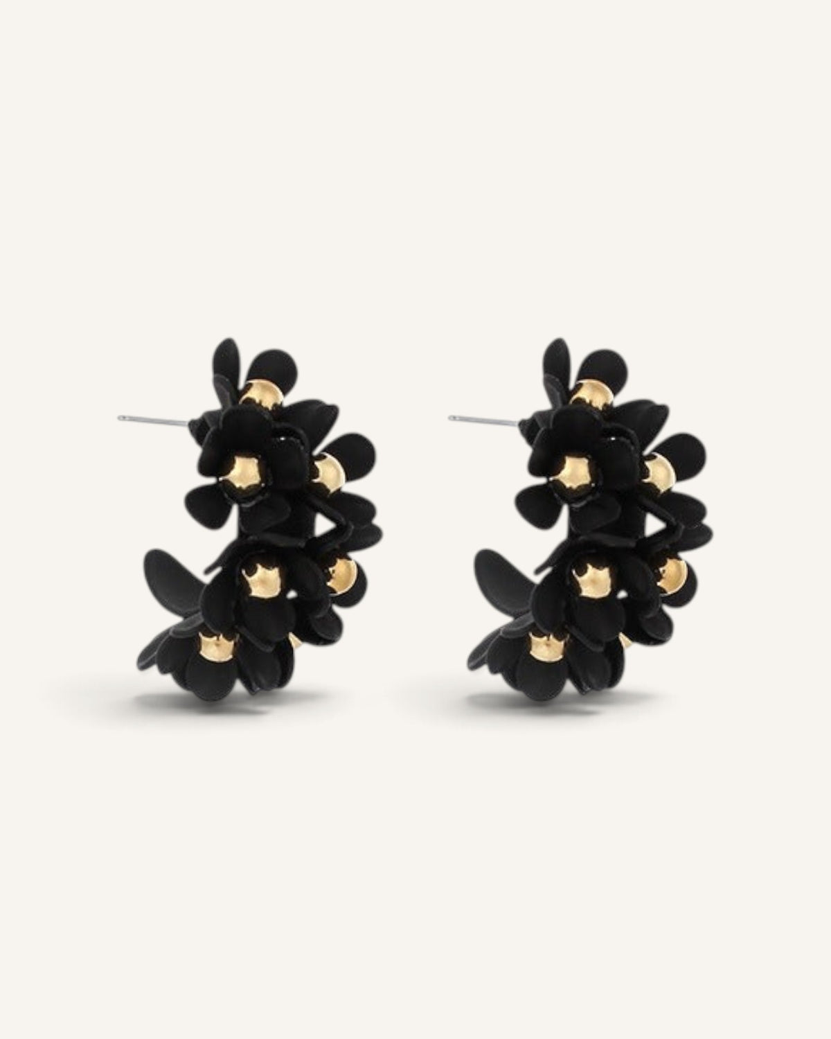 Lunéra de Paris matte black U-shaped hoop earrings featuring dimensional floral motifs with polished gold centers.