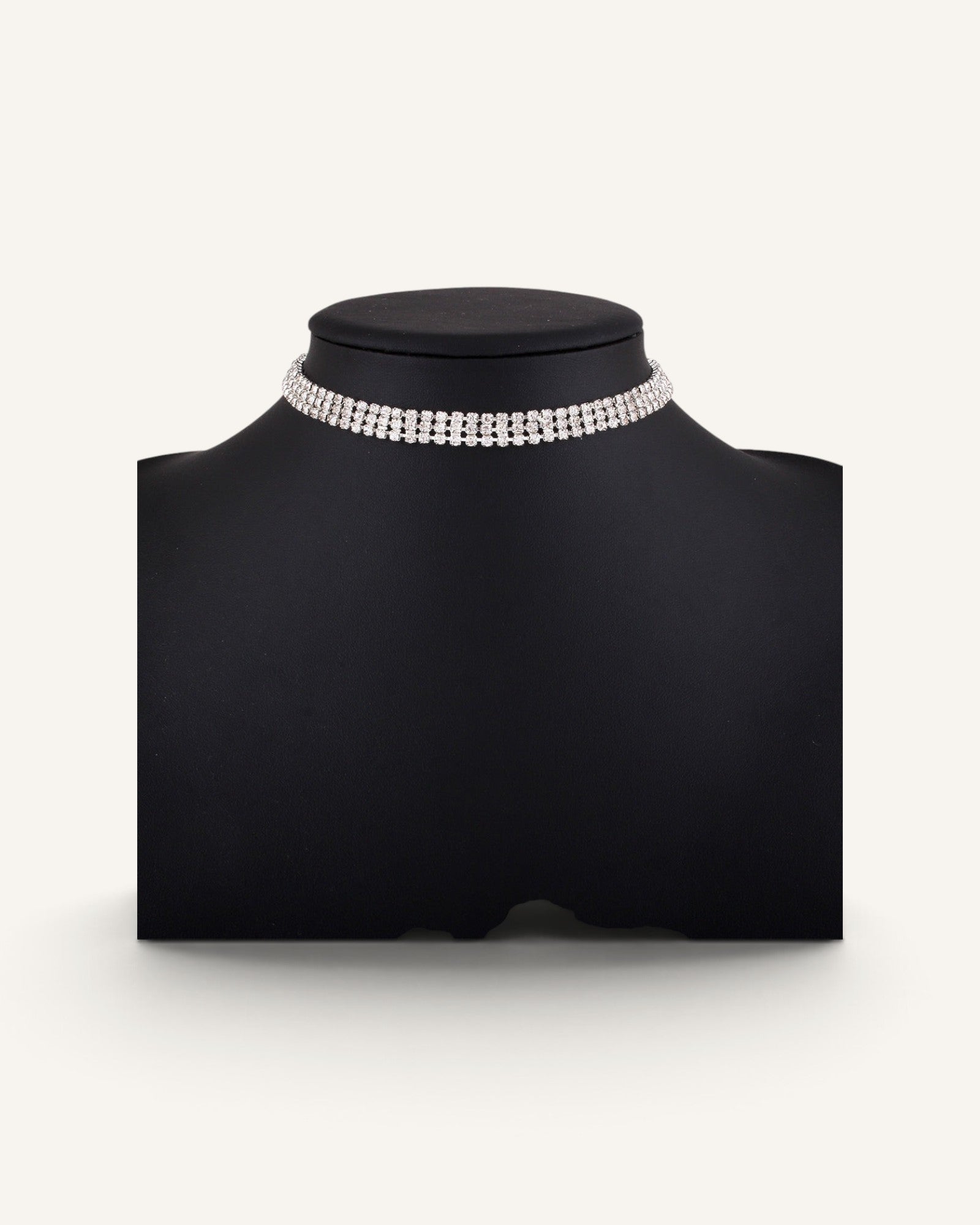 Lunéra de Paris multi-row rhinestone choker necklace on a black display bust, featuring sparkling silver stones.