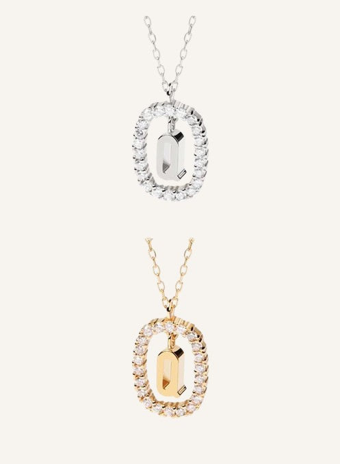 Lunéra de Paris gold and silver pavé oval initial Q pendant necklaces with delicate chains on a neutral background
