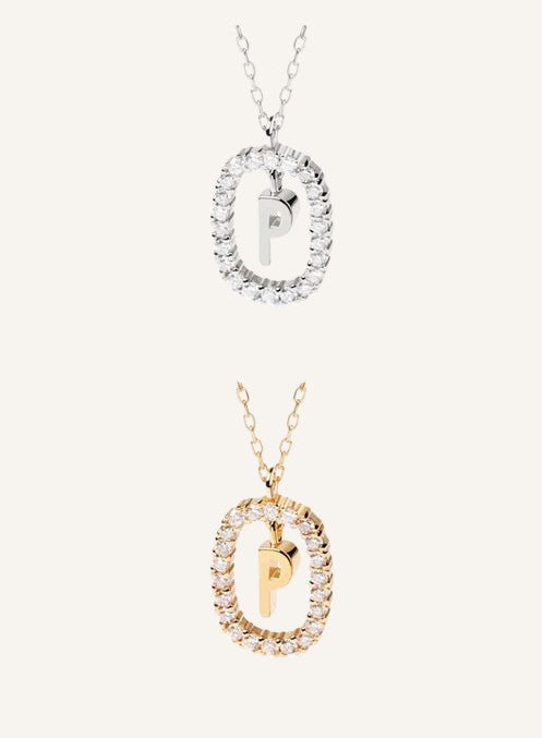 Lunéra de Paris gold and silver pavé oval initial P pendant necklaces with delicate chains on a neutral background.
