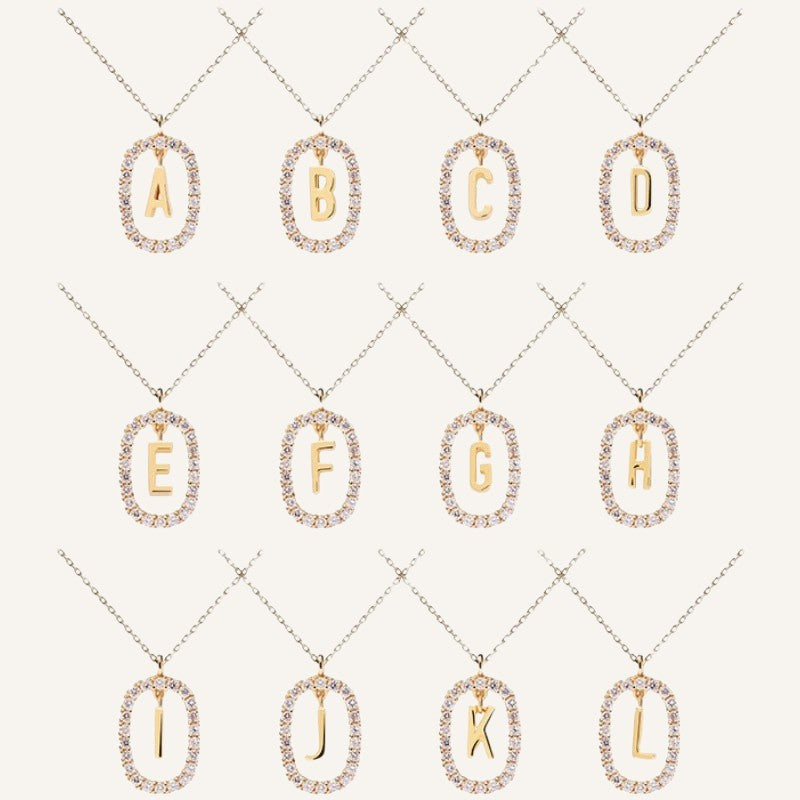 Lunéra de Paris gold pavé oval initial pendant necklaces featuring sparkling crystal borders on delicate chains