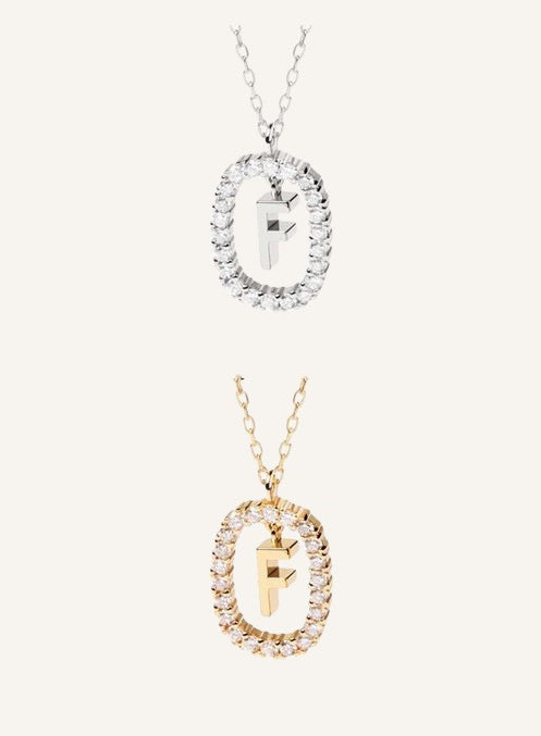 Lunéra de Paris pavé oval initial F pendant necklace in gold and silver tones with sparkling crystal accents.