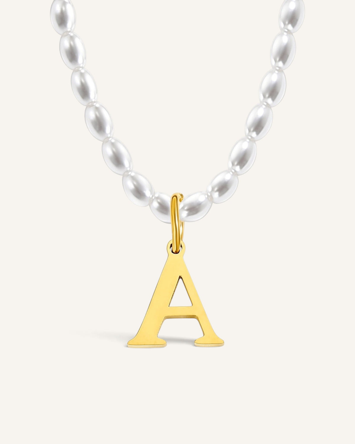 Lunéra de Paris pearl strand necklace featuring a gold-toned initial letter A pendant on a white background