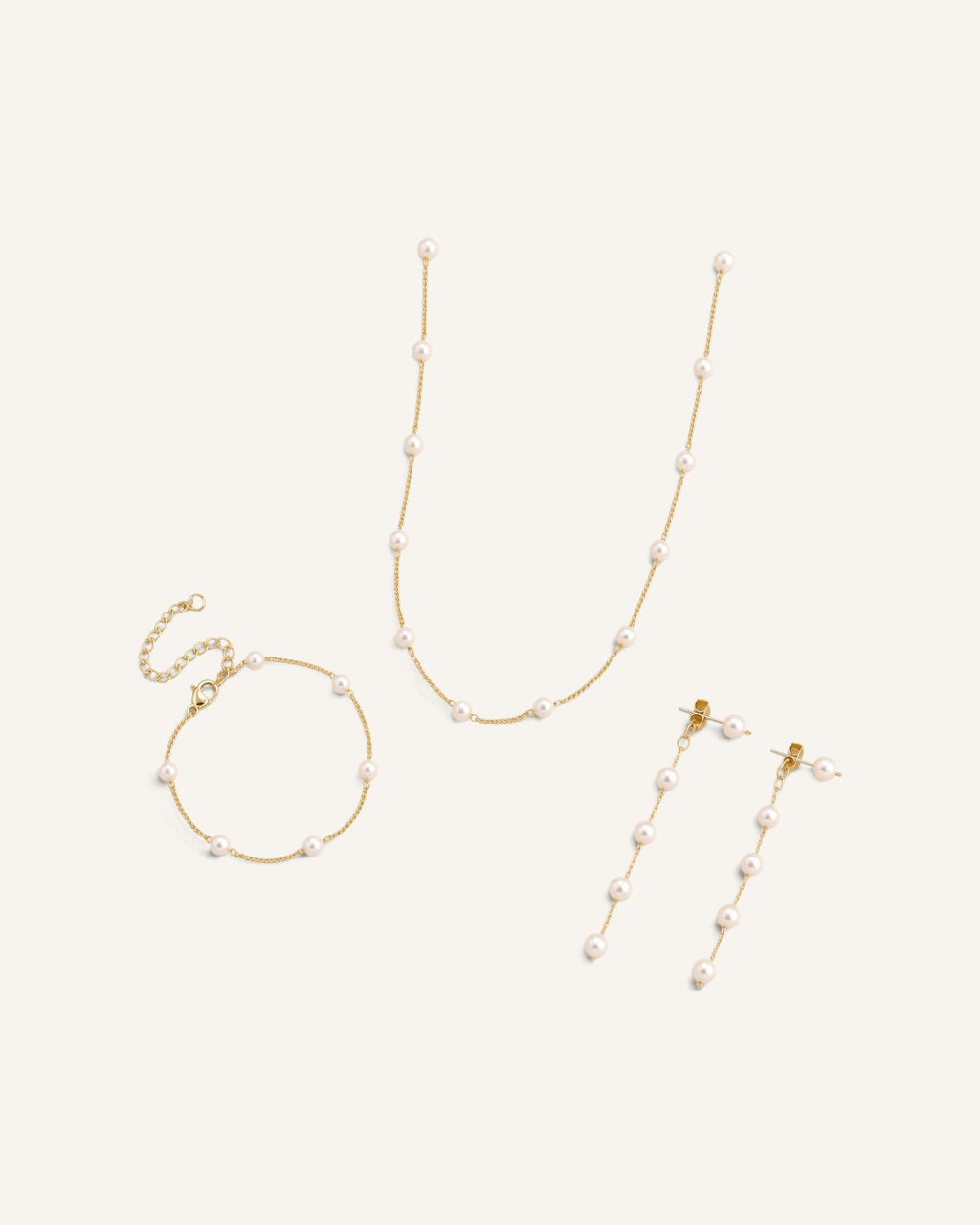 Lunéra de Paris three-piece jewelry set featuring gold-tone chains with delicate station-style white pearls