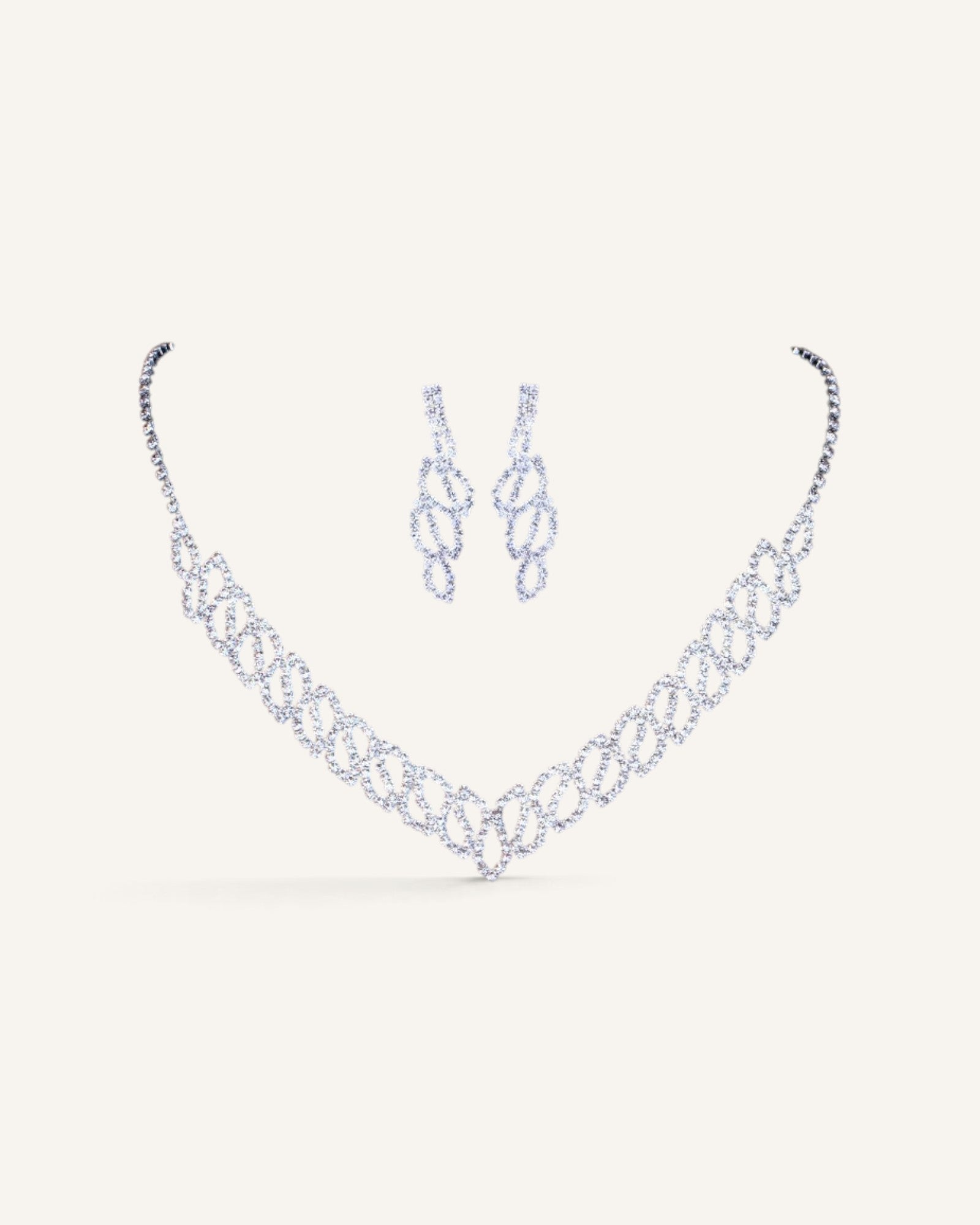 Lunéra de Paris silver V-silhouette jewelry set featuring a rhinestone necklace and matching drop earrings
