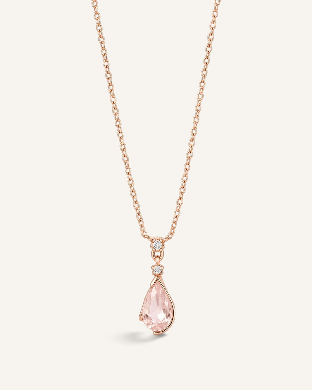 Lunéra de Paris rose gold necklace with a pink teardrop pendant and delicate leaf-inspired setting on a thin chain.