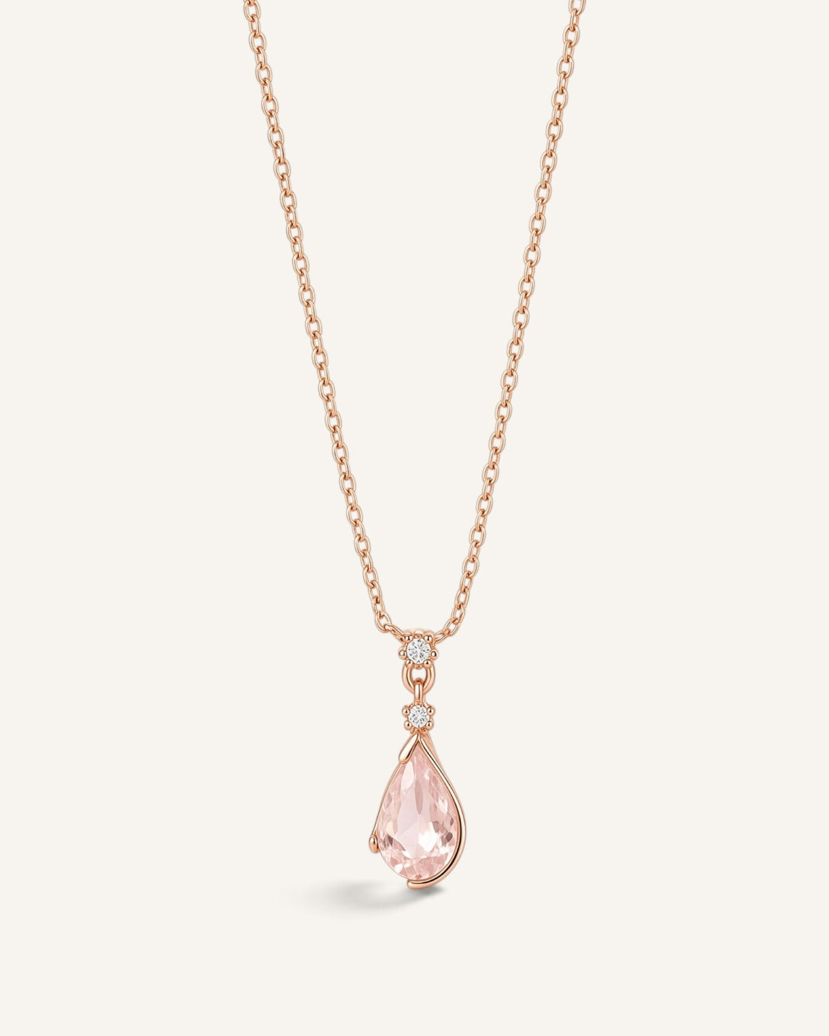 Lunéra de Paris rose gold necklace with a pink teardrop pendant and delicate leaf-inspired setting on a thin chain.