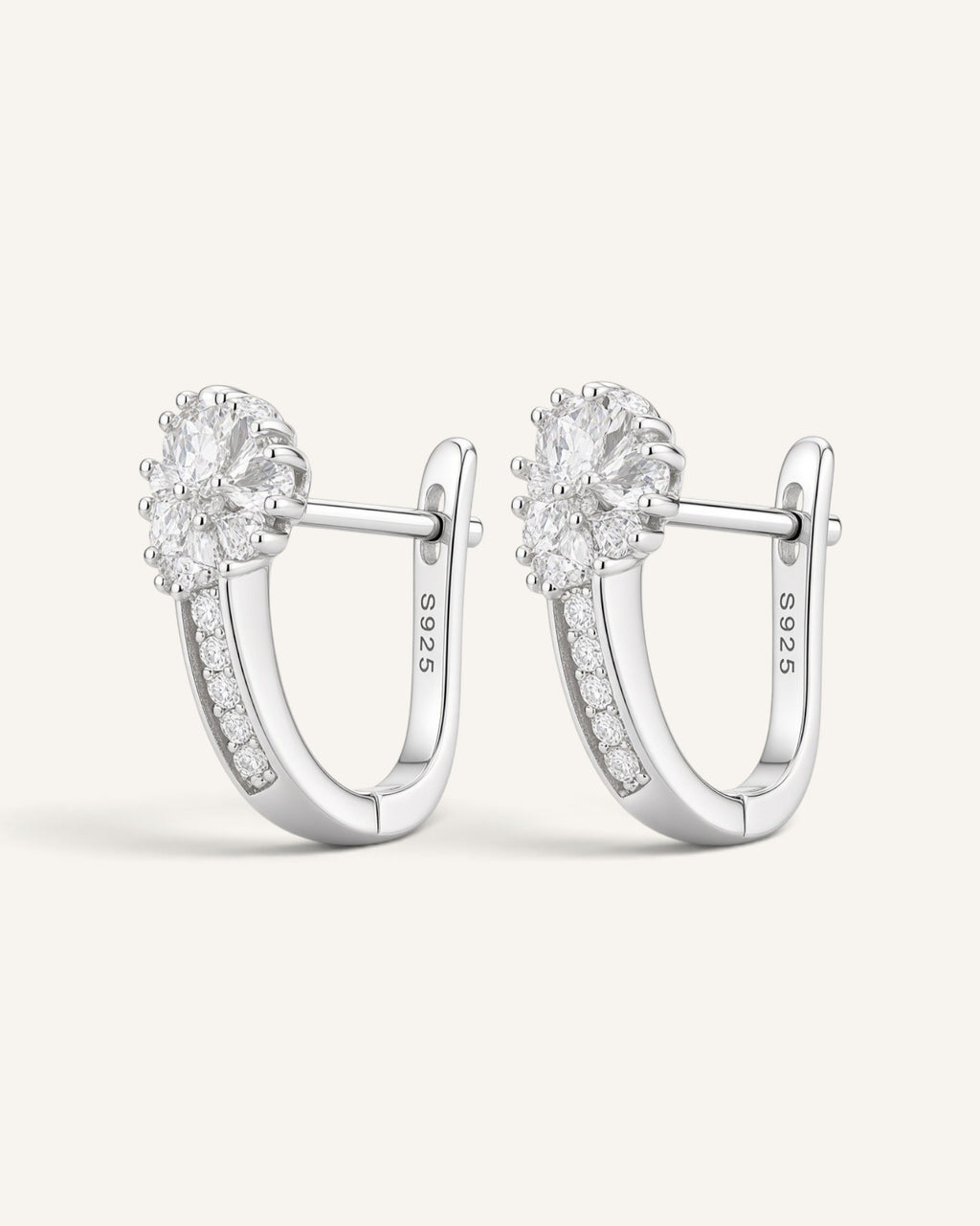 Lunéra de Paris silver-tone hoop earrings featuring a floral cluster of clear stones and a secure hinged closure.