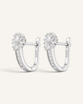 Lunéra de Paris silver-tone hoop earrings featuring a floral cluster of clear stones and a secure hinged closure.