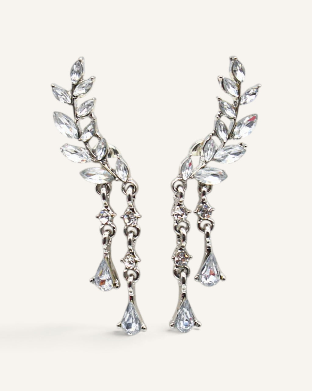 Lunéra de Paris silver leaf stud earrings with dangling crystal teardrop accents and botanical design