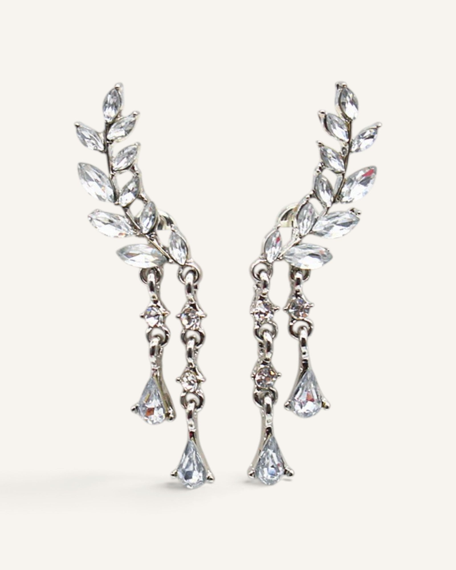 Lunéra de Paris silver leaf stud earrings with dangling crystal teardrop accents and botanical design