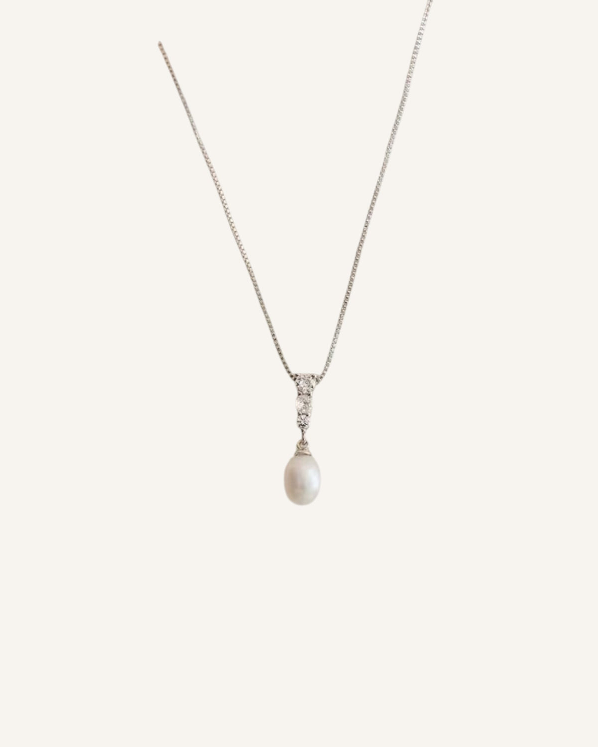 Lunéra de Paris silver-tone necklace featuring a teardrop pearl pendant with a trio of sparkling accents on a fine chain