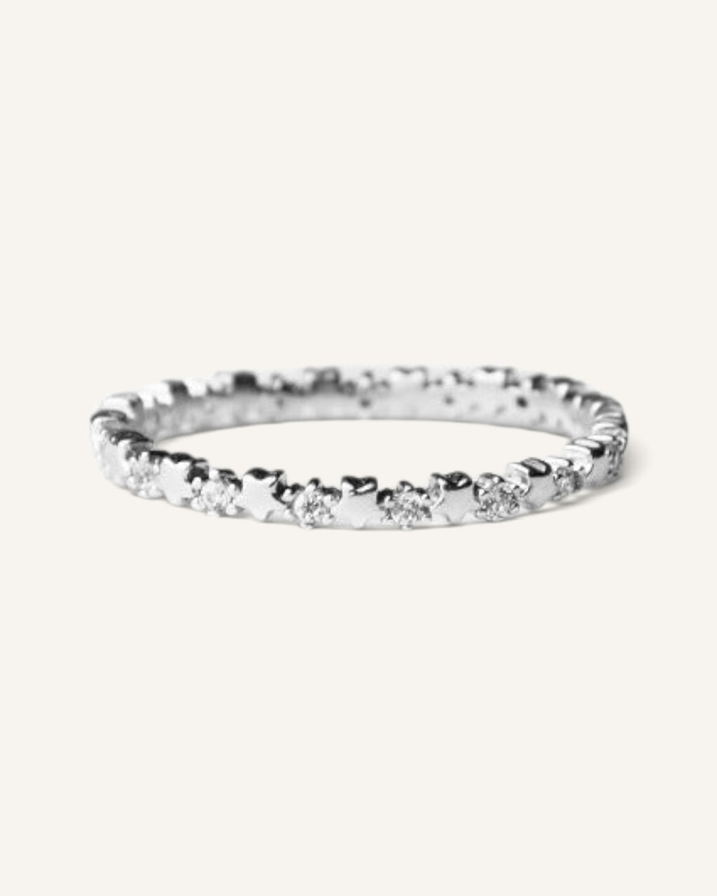 Lunéra de Paris silver-tone stackable ring featuring a delicate band with repeating star motifs and sparkling accents.