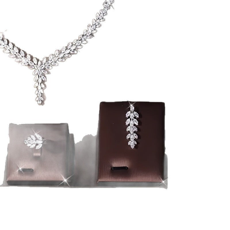 Lunéra de Paris silver zircon jewelry set featuring a necklace, ring, and earring with marquise-cut leaf motifs.