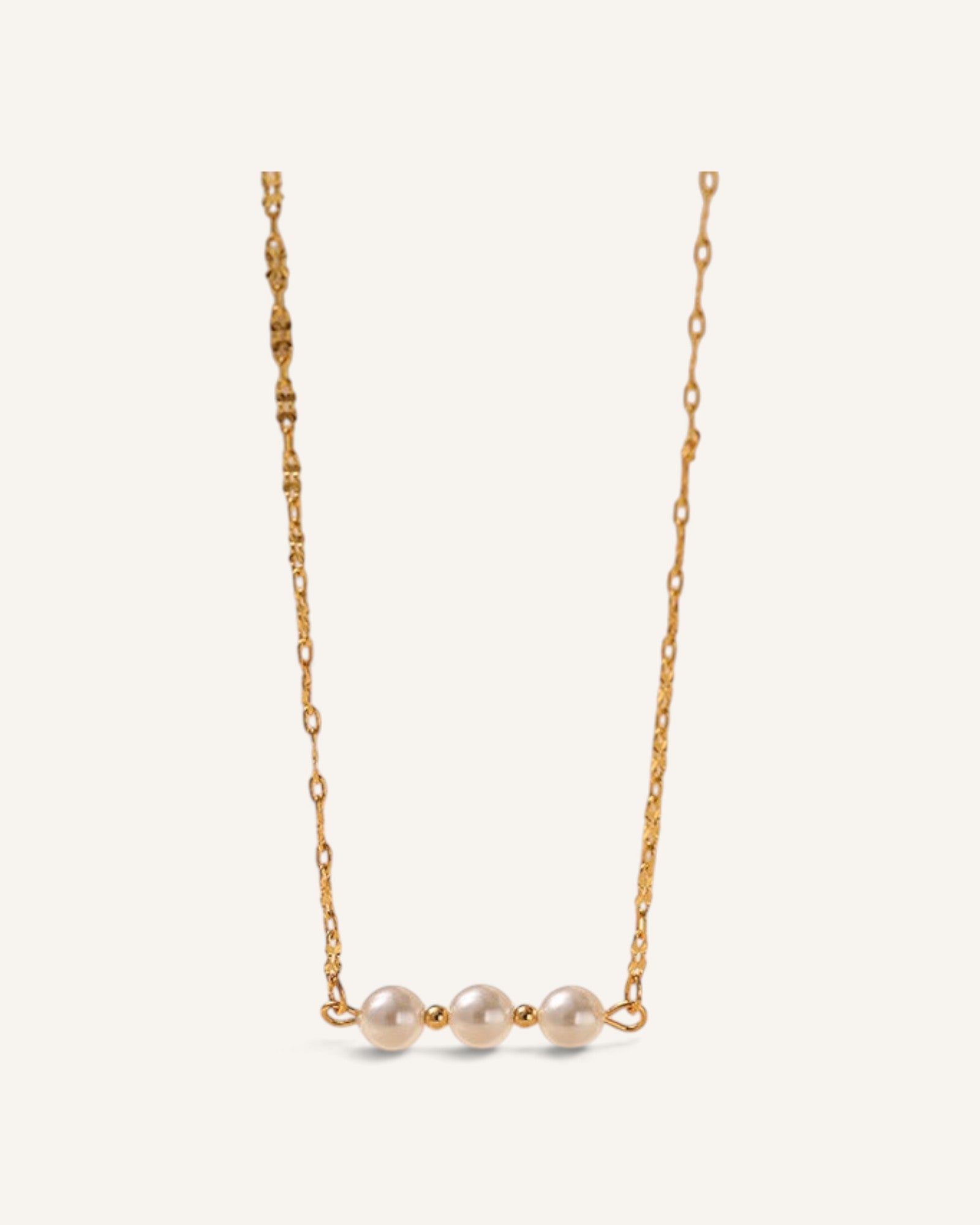 Lunéra de Paris triple shell pearl station necklace on a delicate gold-plated textured link chain