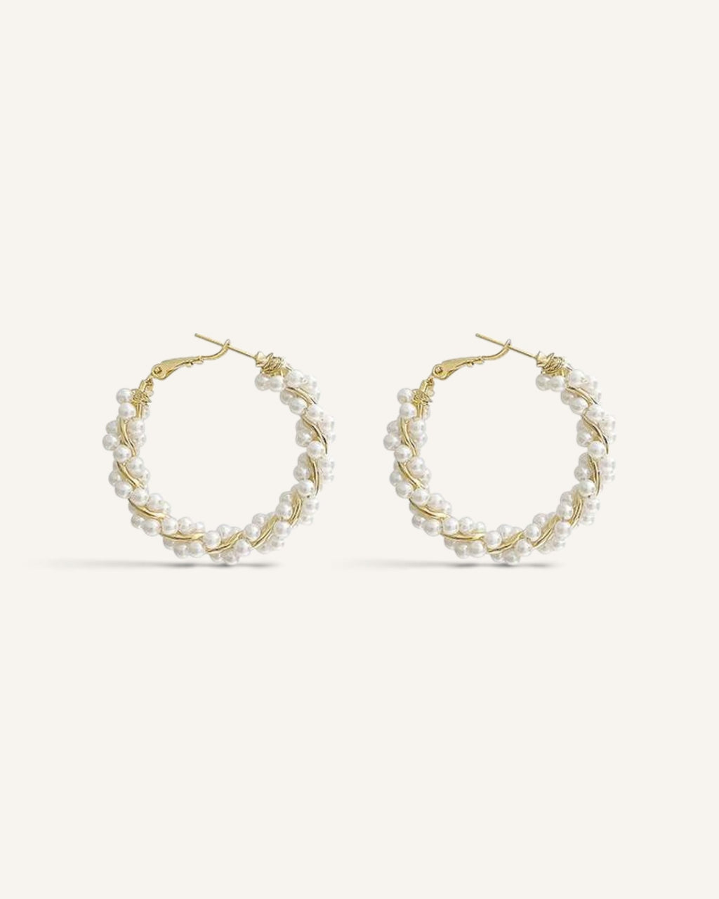 Lunéra de Paris gold-tone twisted hoop earrings featuring delicate white faux pearl embellishments