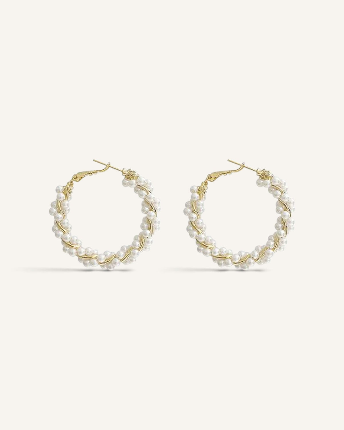 Lunéra de Paris gold-tone twisted hoop earrings featuring delicate white faux pearl embellishments