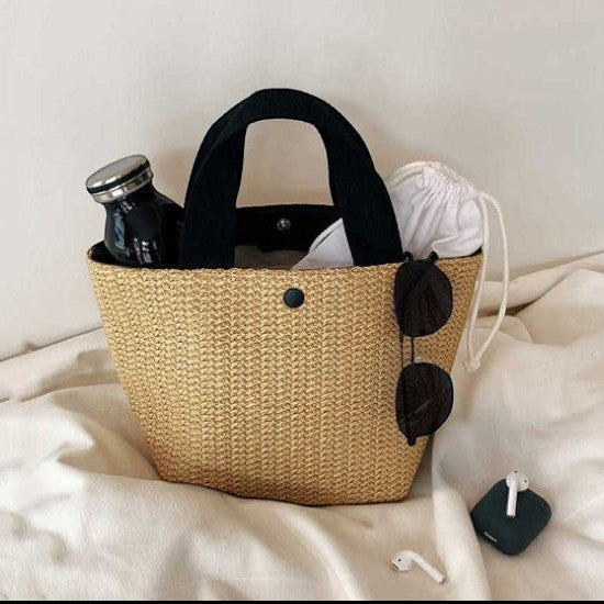 Lunéra de Paris Riviera woven beach bag with a tan textured body and contrasting black top handles
