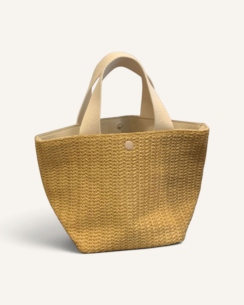Lunéra de Paris Riviera woven beach bag with a tan textured body and contrasting cream top handles