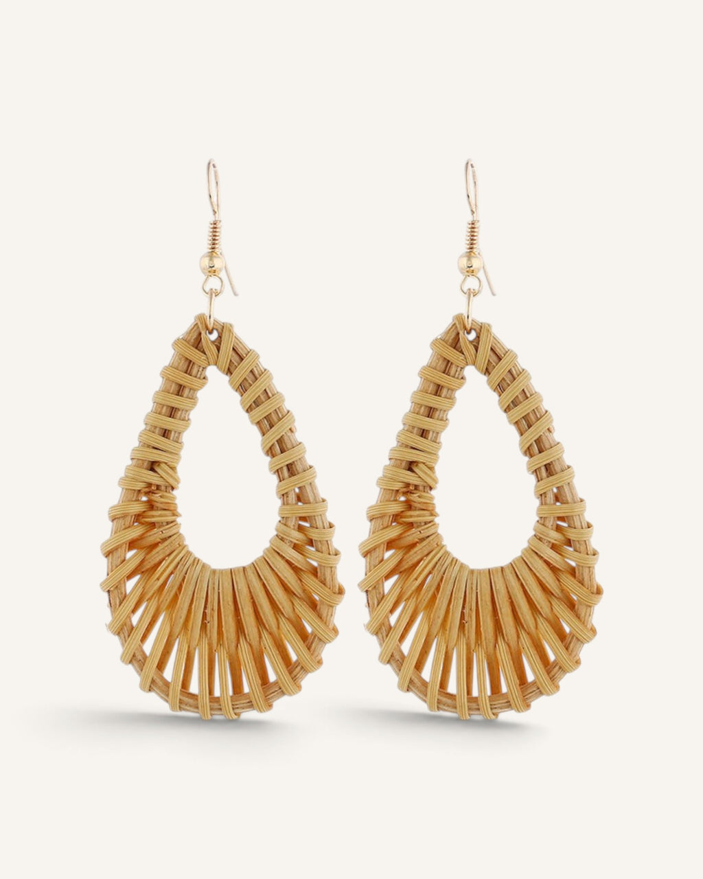 Lunéra de Paris woven rattan teardrop earrings with gold-tone hook closures on a light background